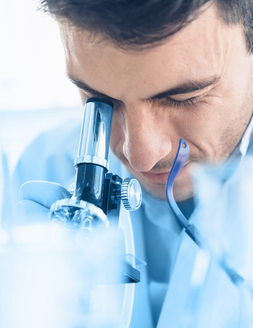 Public health researcher using a microscope
